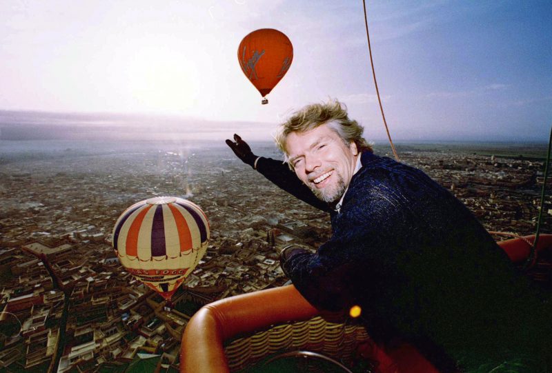 British multi-millionaire Richard Branson points at other hot air balloons flying over the city of Marrakesh January 18. Branson plans to do a round-the-world trip in the Virgin Global Challenger along with Swedish Per Lindstrand and Rory McCarthy. The balloon's cabin will be sealed and pressurized to enable the crew to drift in the jetstream at an altitude of 10.000 meters 