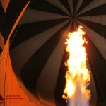 The basket of a hot-air balloon is suspended beneath the canopy