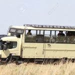 MASAI MARA, KENYA-OCTOBER 20: A Safari bus in the grassland of Masai Mara for game drive in Masai Mara National Reserve (National Park) on October 20, 2013 in Masai Mara, Kenya, Africa.