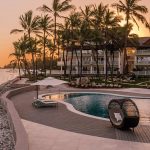 2 pools surrounded by palm trees