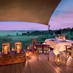 Romantic lantern lit dining overlooking the Maasai Mara at Andbeyond Bateleur Camp