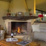 Asilia Ol Pejeta bush camp lounge area with fire