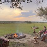 Encounter Mara camp guests campfire